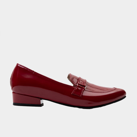 Maroon patent leather pointed-toe penny loafer flat with buckle strap and 1-inch block heels