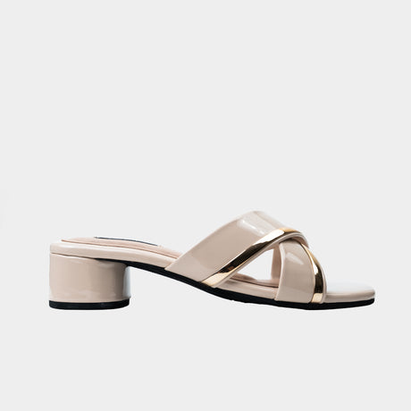 Nude patent leather crisscross slide sandal with metallic gold trim and 2-inch low block heel.