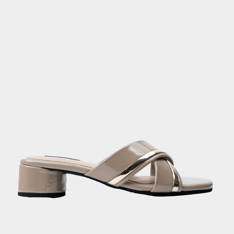 Taupe patent leather crisscross slide sandal with metallic gold trim and 2-inch low block heel.
