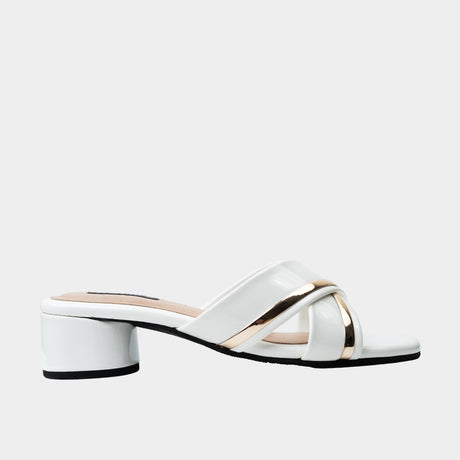 White patent leather crisscross slide sandal with metallic gold trim and 2-inch low block heel.